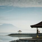 brown gazebo near sea closeup photography